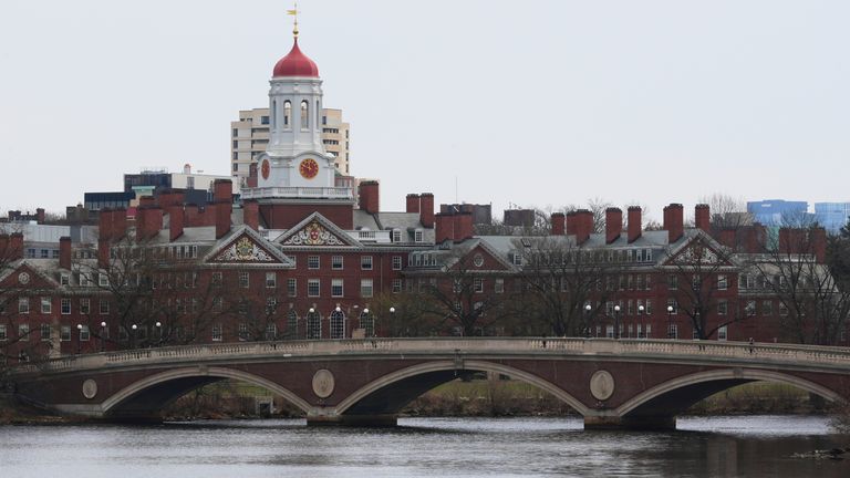 FILE - A sculler rows down the Charles River near Harvard University, at rear, Tuesday, April 15, 2025, in Cambridge, Mass. (AP Photo/Charles Krupa, File)
