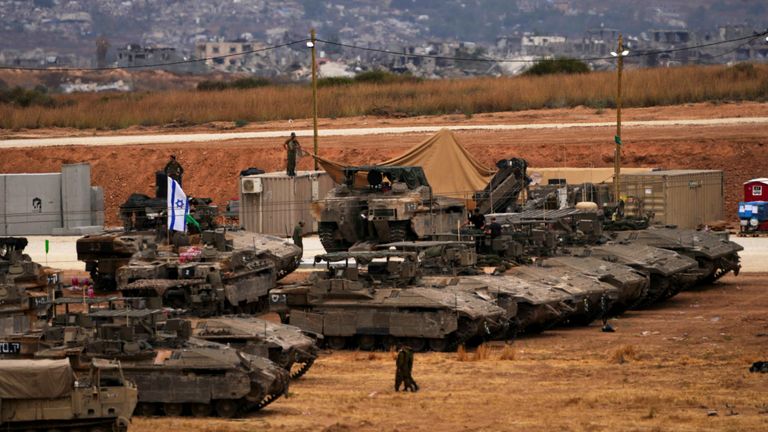 Israeli soldiers work on tanks and APCs at a staging area near the border with the Gaza Strip, in southern Israel, Thursday, May 15, 2025. (AP Photo/Ariel Schalit)