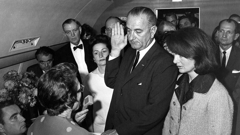Judge Sarah T. Hughes (L) administers the Presidential Oath of Office to then acting U.S. President Lyndon Baines Johnson (C) aboard Air Force One at Love Field in Dallas Texas, in this handout image taken on November 22, 1963. Former first ladies' Lady Bird Johnson and Jacqueline Kennedy (R), widow of former U.S. President John F. Kennedy, listen along with other witnesses. November 22, 2013 will mark the 50th anniversary of the assassination of President Kennedy. REUTERS/Cecil Stoughton/The Wh