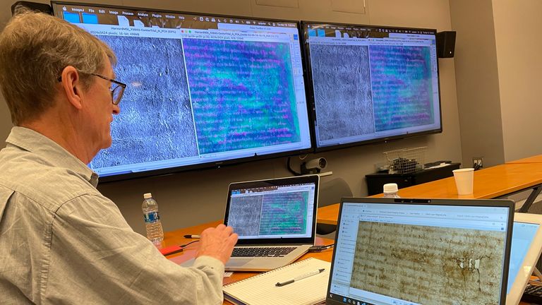 A librarian is examining the results of imaging technology used on the faded Magna Carta copy. Pic: AP