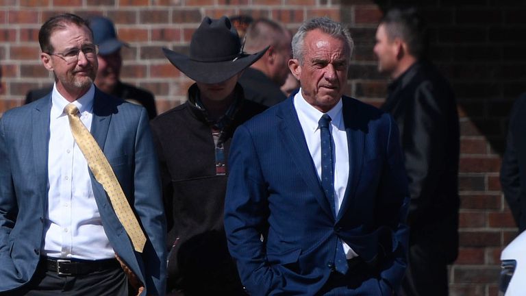 Health and Human Services Secretary Robert F. Kennedy Jr., right, arrives at Reinlander Mennonite Church after a second measles death, Sunday, April 6, 2025, in Seminole, Texas. (AP Photo/Annie Rice)