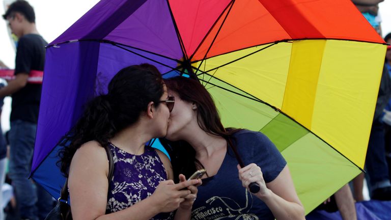 A gay couple kisses each other as thousands of catholics and conservatives gather together against the legalization of gay marriage and to defend their interpretation of traditional family values in Monterrey City, Mexico September 10, 2016. REUTERS/Daniel Becerril