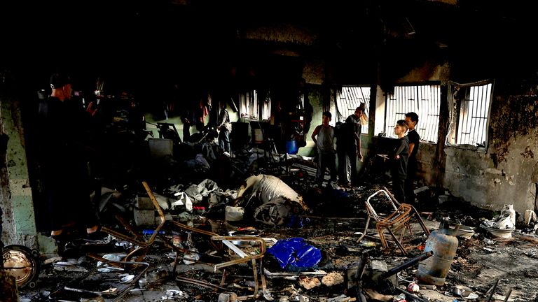 Palestinians inspect the damage at a school sheltering displaced people, following an Israeli strike, in Gaza City, May 20, 2025. REUTERS/Dawoud Abu Alkas