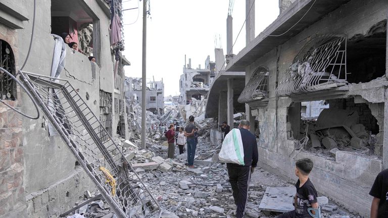 Palestinians inspect the rubble of homes destroyed by Israeli airstrikes in Jabalia, northern Gaza Strip, on Wednesday, May 14, 2025. According to local hospitals, 48 people were killed in the strikes, including 22 children. (AP Photo/Jehad Alshrafi)
