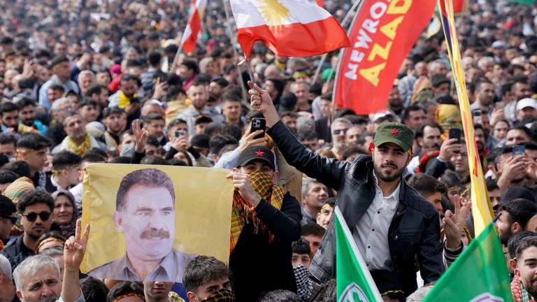FILE PHOTO: A person holds a flag with an image of jailed Kurdish militant leader Abdullah Ocalan during a gathering to celebrate the spring festival of Newroz in Istanbul, Turkey, March 23, 2025. REUTERS/Tolga Uluturk/File Photo