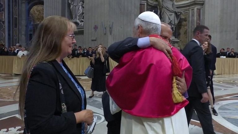The pope's brother Louis Provost hugs him as his wife watches on