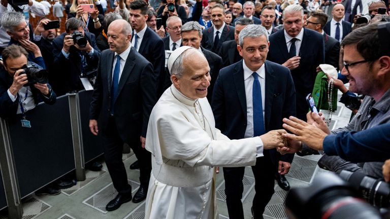 Pope Leo XIV shakes hand with a person, on the day of an audience with representatives of the media in Paul VI hall at the Vatican, May 12, 2025. REUTERS/Eloisa Lopez