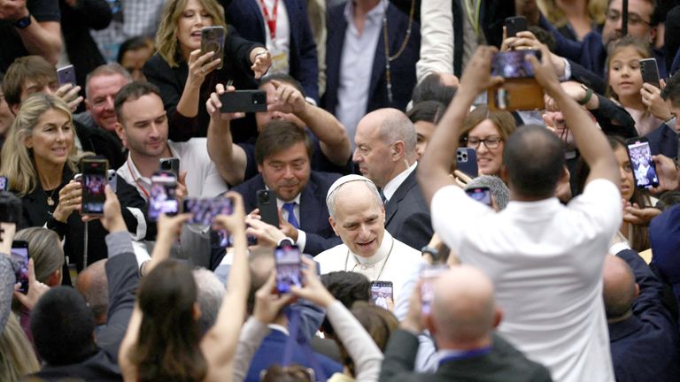 Pope Leo XIV speaks with people at the end of an audience with representatives of the media in Paul VI hall at the Vatican, May 12, 2025. REUTERS/Guglielmo Mangiapane
