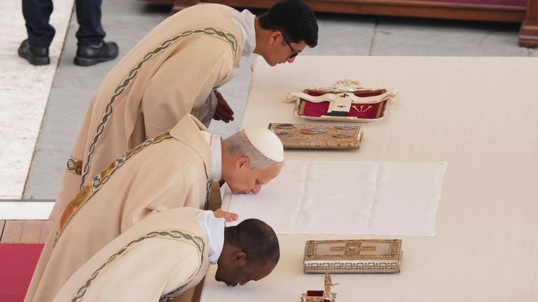 The pope kisses the altar. Pic: AP