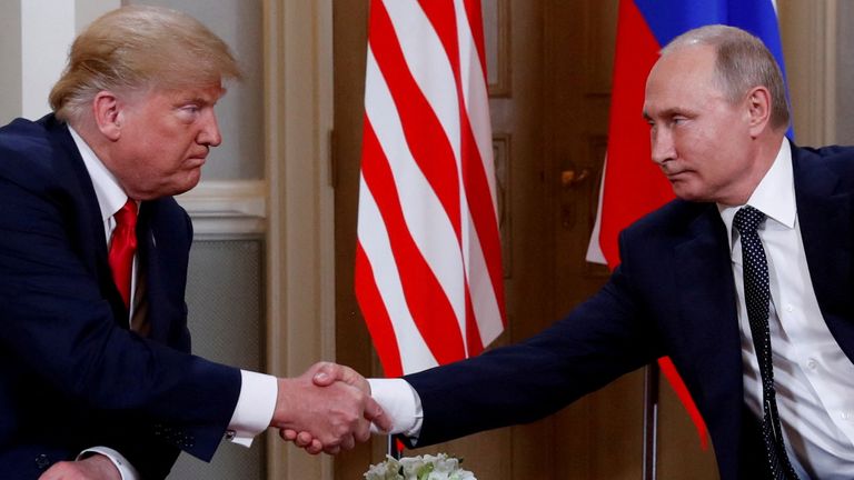 FILE PHOTO: U.S. President Donald Trump and Russia's President Vladimir Putin shake hands as they meet in Helsinki, Finland July 16, 2018. REUTERS/Kevin Lamarque/File Photo