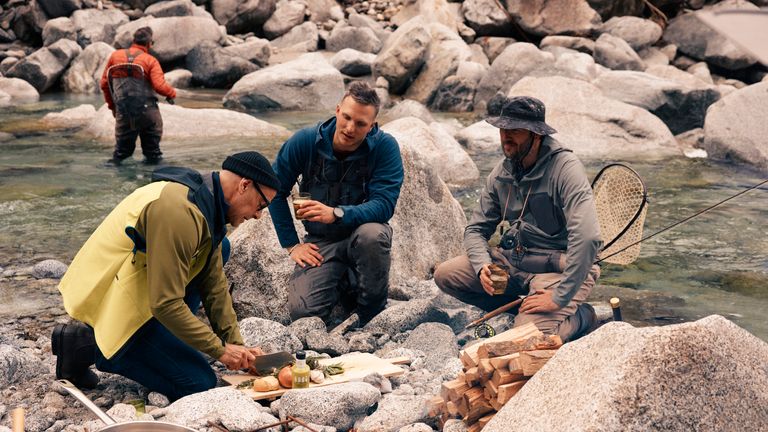 Mr Tucci fly fishes in a glacial river with locals. Pic: National Geographic/Matt Holyoak