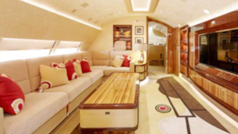 Inside the Qatari plane Mr Trump wants to use as a replacement for Air Force One. An open seated area with a sofa, large coffee table and larger TV.  Pic: Amac Aerospace