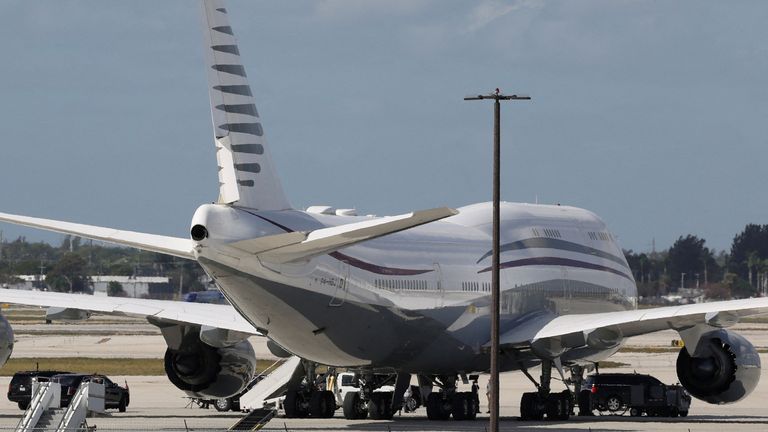 Mr Trump's motorcade parked next to a 12-year-old Qatari-owned Boeing 747-8 that the US president was touring in West Palm Beach, Florida, in February.  Pic: Reuters/Kevin Lamarque