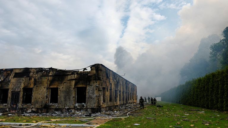 Firefighters at the site of a business premises struck by a drone outside Kyiv. Pic: Reuters