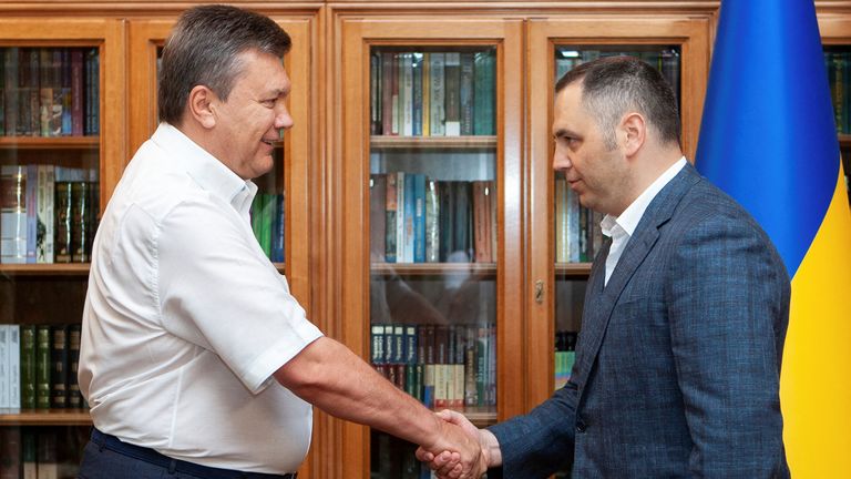 Viktor Yanukovych and Andriy Portnov shake hands in Kyiv.  Pic: Reuters