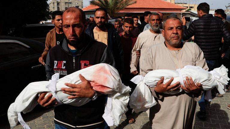 Palestinians carry the bodies of the two children, Moath and Moataz Al-Bayouk, who were killed in Israeli strikes, at Nasser hospital in Khan Younis, southern Gaza Strip, May 15, 2025. REUTERS/Hatem Khaled TPX IMAGES OF THE DAY