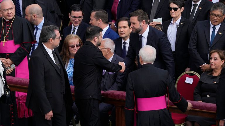 Ukrainian President Volodymyr Zelenskyy shakes hands with JD Vance. Pic: AP