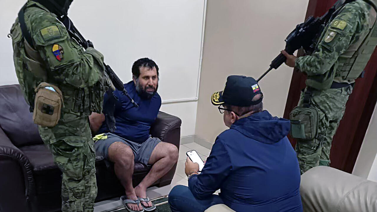 Drug trafficker Adolfo Macias (2nd L), alias Fito, talking with Ecuador's Interior Minister John Reimberg (2nd R) after his recapture in Manta, Manabi Province, Ecuador, on June 25, 2025.
